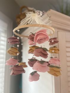 a pink rose mobile hanging from the ceiling