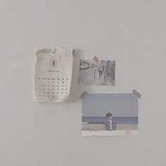 a white wall with pictures and photos hanging on it's side next to a piece of paper