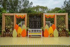 a white bench sitting in front of a decorated stage