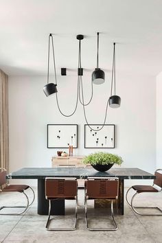 an elegant dining room with modern lighting fixtures