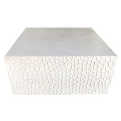 a white table with an interesting pattern on it's surface and the top is made out of concrete