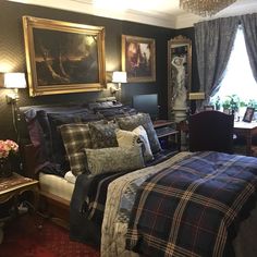 a bed room with a neatly made bed and paintings on the wall