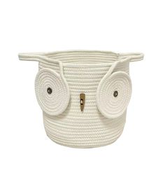 a white basket with an owl face on it