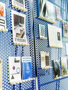 a blue wall covered in pictures and magnets with photos on it's sides