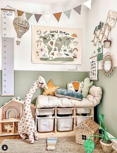 a child's room with toys and decor on the wall, including a toy giraffe