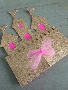 a cardboard castle with pink and gold decorations