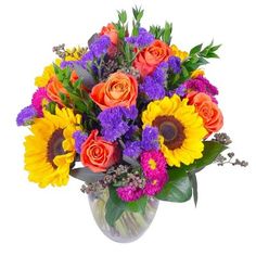 a vase filled with lots of colorful flowers