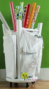 a white bag filled with lots of different types of pens and pencils on top of a wooden floor