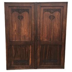 an old wooden double door with carvings on the front and side panels, isolated against a white background