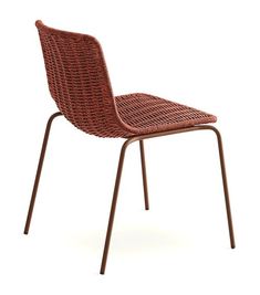 an orange chair with metal legs and a wicker seat on the back, against a white background