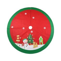 a green and red christmas tree skirt with snowman, santa clause and reindeer on it