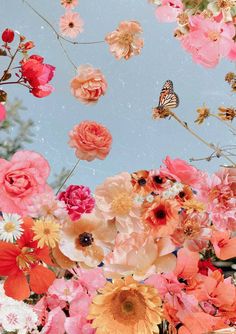 a bunch of flowers that are in the air with a butterfly flying over them on a blue sky background