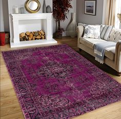 a living room filled with furniture and a purple rug