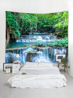 a bed room with a neatly made bed and a waterfall wall hanging on the wall