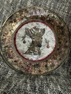 a decorative plate with an image of a deer on it