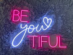 a neon sign that says be your tiful