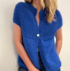 a woman wearing a blue sweater and jeans