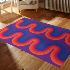 a colorful rug on the floor in a living room with a chair and radiator