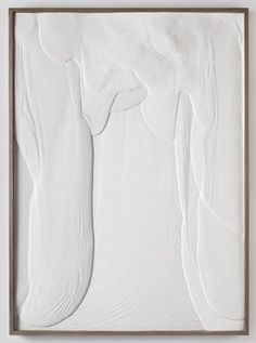 an abstract painting with white paint and wood frame on the wall, it looks like there is