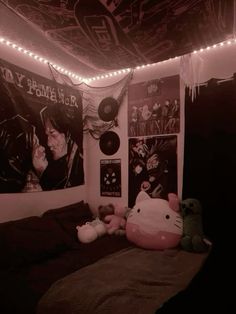 a bedroom decorated in pink and black with posters on the wall