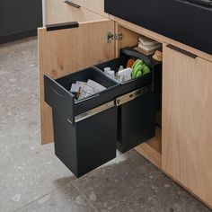 two black trash cans are open in the kitchen