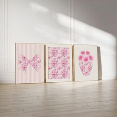 three framed pictures with pink and white designs on them, one is a baby's foot