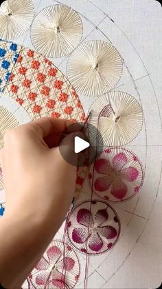 someone is working on an art project with paper umbrellas in the shape of flowers