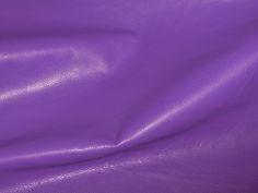 a close up view of a purple leather textured material that looks like it has been dyed