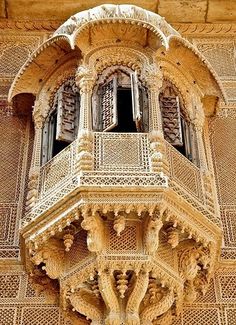 an ornate balcony and balconies on the side of a building with intricate carvings