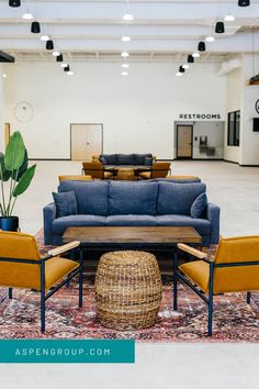 a living room with couches, chairs and rugs on the floor in front of it