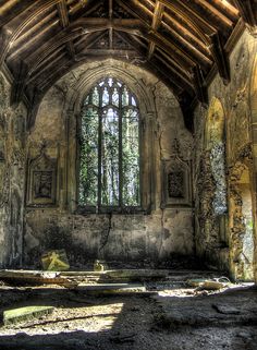 the inside of an old building with stone walls and windows