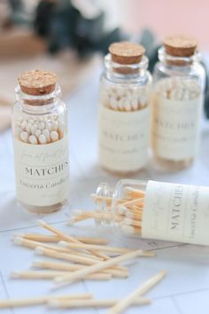 several small bottles filled with matches on top of a table