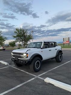 a white pick up truck parked in a parking lot