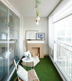 a balcony with green carpet and wicker furniture next to a fire place in the corner