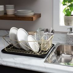 a kitchen counter with dishes and silverware on it