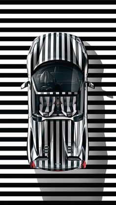 a white car with black and white stripes on it's hood is shown from above