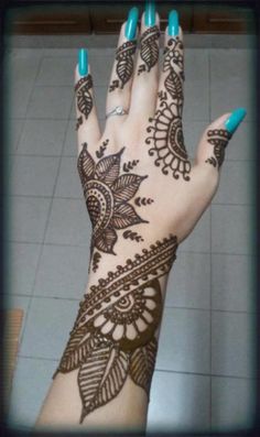 a woman's hand with henna on it