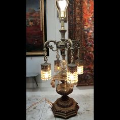 an old fashioned chandelier is on display in a room with other antique items