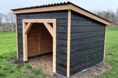 a dog house built in the middle of a field