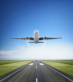 an airplane is taking off from the runway on a clear day with blue sky in the background