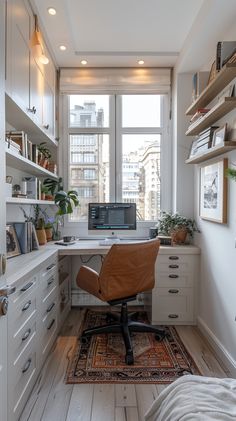 a home office with white cabinets and lots of natural light in the window sill