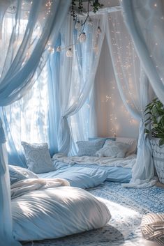 a canopy bed with white drapes and lights hanging from it's sides in a bedroom