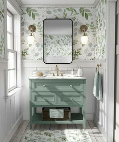 a bathroom with green and white wallpaper on the walls, two sinks and a mirror