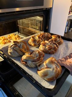 freshly baked pastries sit in front of an oven