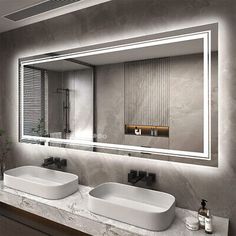 a bathroom with two sinks and a large mirror above it's countertop area