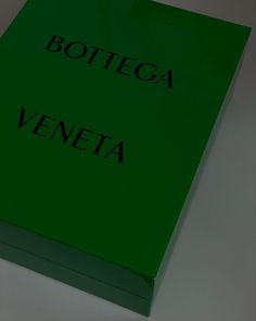 a green box with the words bottega veneta on it