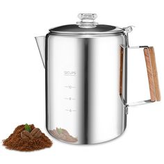 a stainless steel coffee pot with wooden spoons next to it