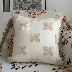 a white pillow sitting on top of a couch