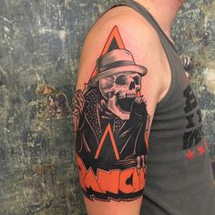 a man with a hat and skull tattoo on his arm