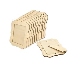 several wooden coasters with different shapes and sizes on them, one has a blank card in the middle